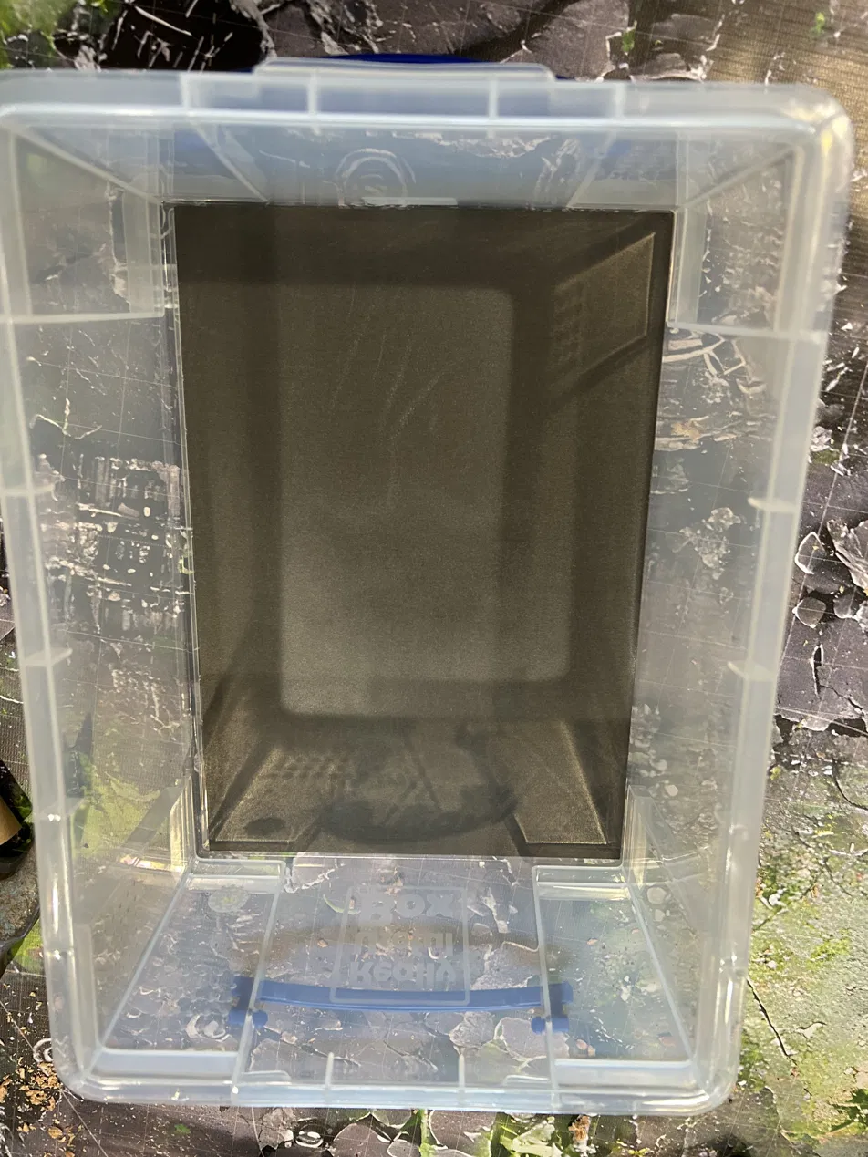 The adhesive magnetic sheet installed edge-to-edge in the bottom of the empty 9-liter box